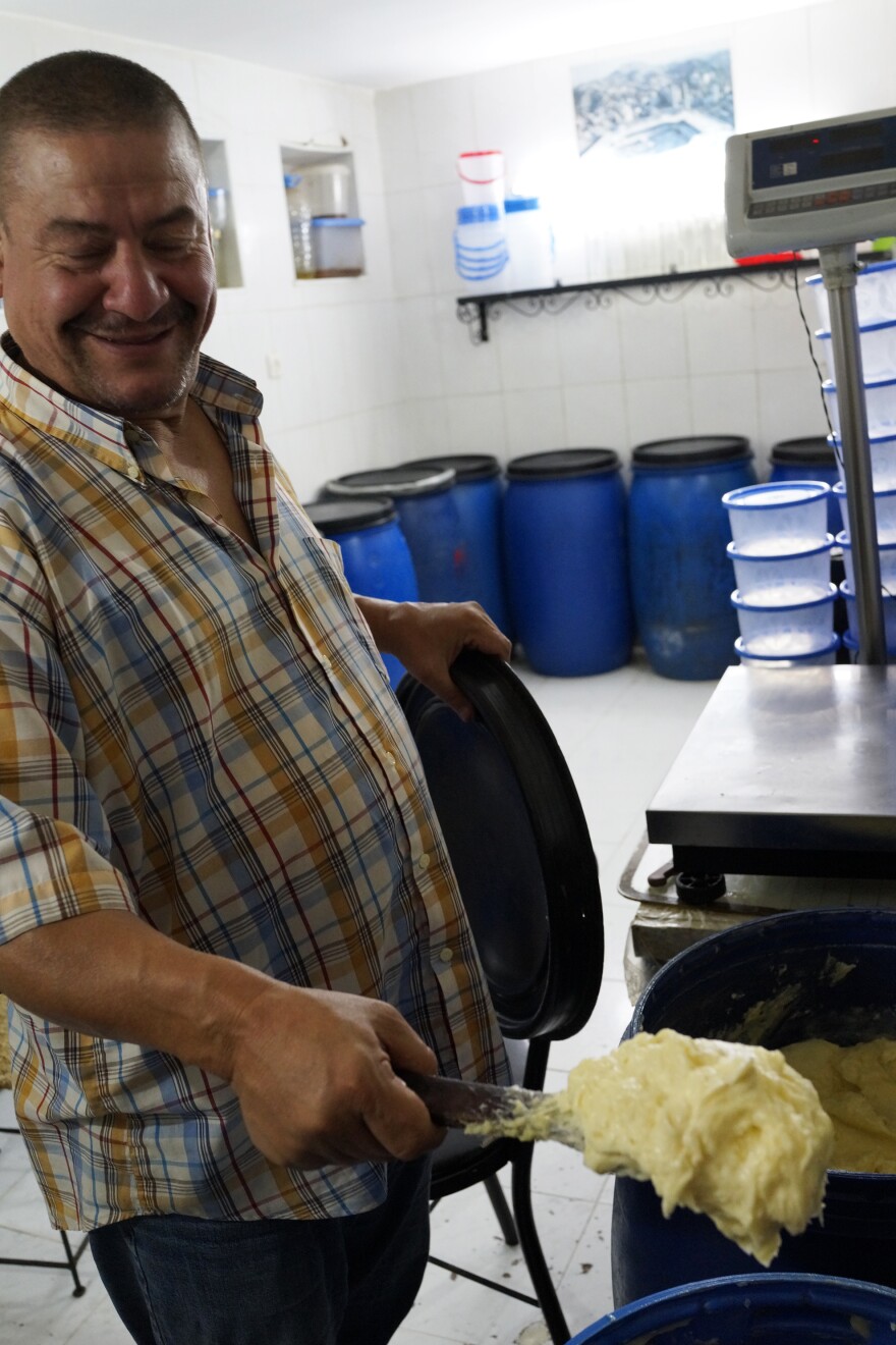 Abdelali Sheikh's family has been in the smen business for 150 years. He operates a storefront in Smen Square that's lined with blue plastic barrels and outfitted with a brass scale to measure out his products.