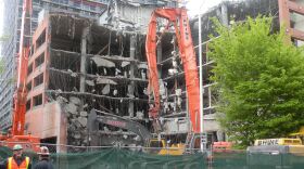 Demolition begins on the garage of the McGuire Apartments tower, in Seattle.