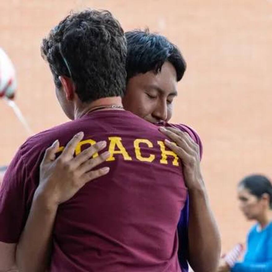 Luma Mufleh and Ernesto Manuel-Andres embracing after the teen was released on bond.