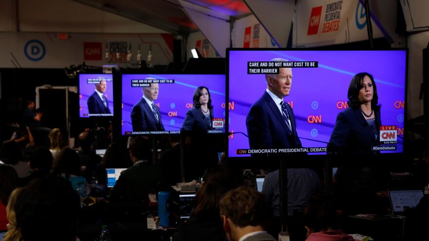 Vice President Joe Biden and Sen. Kamala Harris, D-Calif., as seen on televisions in the press room during the Democratic primary debate in Detroit, Mich.