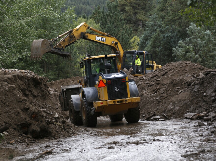 Heavy equipment works to clear a Jamestown road after a landslide covered it with more than 20 feet of mud.
