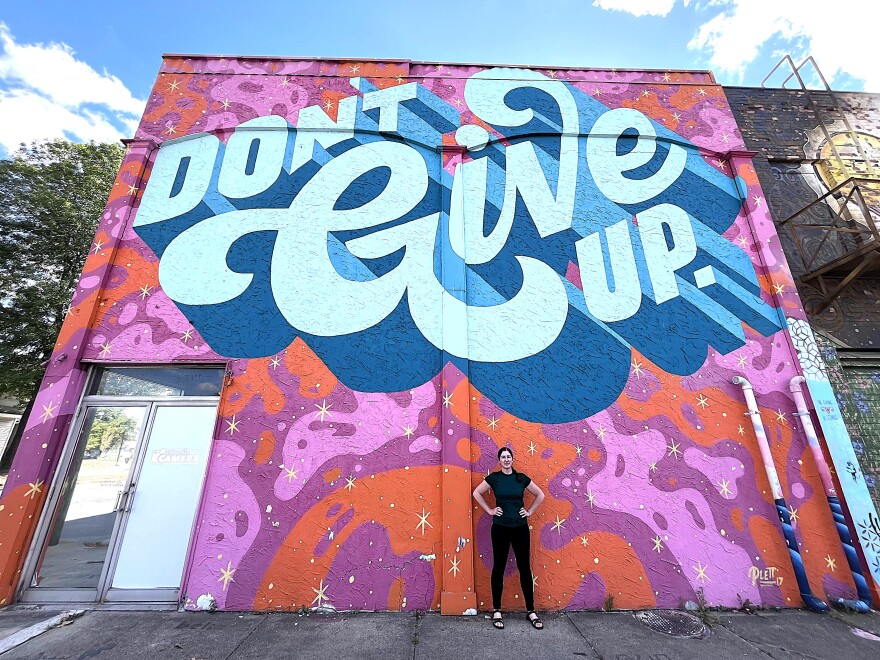 Hickey, in front of inspirational mural on north face of Wunderkammer Company.