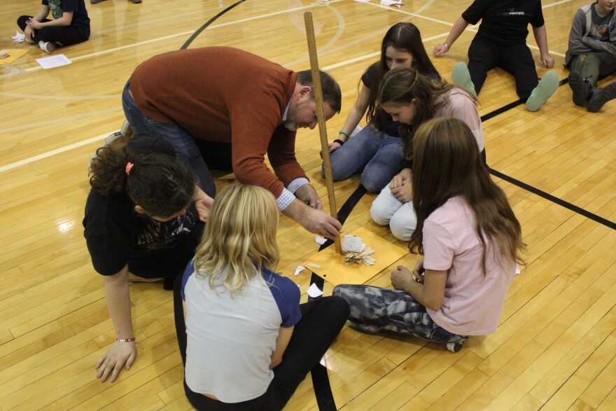 Kenai Peninsula Borough School District Superintendent Clayton Holland measures the height of a tower built during a Mind-A-Mazes competition on Saturday, Oct. 19, 2024 near Soldotna, Alaska.
