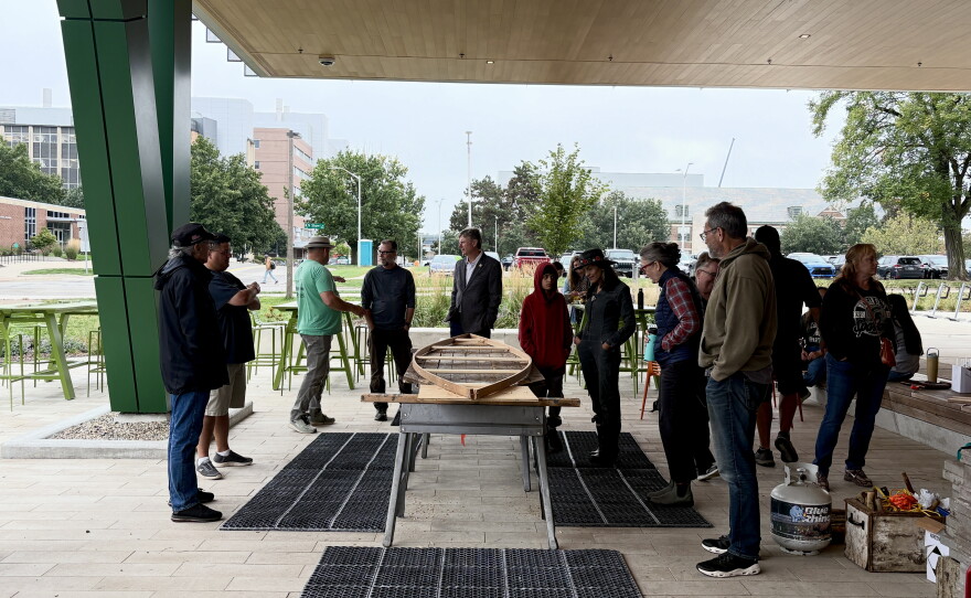 Ron J. Paquin, his apprentices and volunteers building the birch canoe.