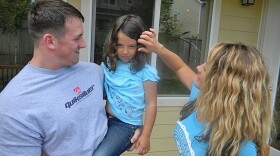 Army Captain Brian Giroux at home in Lacey, Washington with his wife and six-year-old daughter.