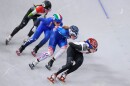 Athletes compete during a short track speed skating women's 1500 meters semifinal at the 2026 Winter Olympics, in Milan, Italy, Friday, Feb. 20, 2026. Corrine Stoddard can be seen with the number 3 on her helmet in second place.