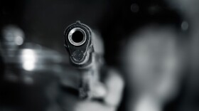 closeup of the barrel of a handgun with the background blurred