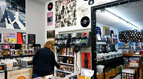 Store owner of Exile Vinyl, Paula Kretkiewicz, adjusts the shelves while awaiting customers. The Branford, Conn. record store is celebrating its 30 year anniversary as it has been around since 1993.