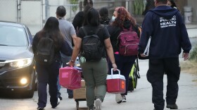 Los Angeles County Public Health Emergency Operations officials leave St. Anthony's Croatian Catholic Church after evaluating newly arrived migrants being housed in the Chinatown area of Los Angeles on June 14, 2023. A group of migrants who arrived by bus from Texas -- including some children -- were dropped off at Union Station Wednesday and were being cared for at the church. Texas Gov. Greg Abbott said the migrants were sent to Los Angeles because California had declared itself a "sanctuary" for immigrants.