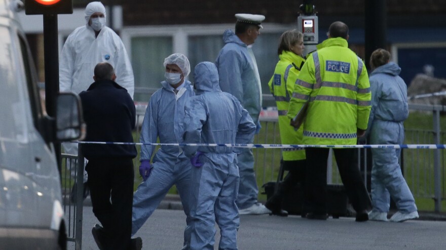 Police and forensic officers near the scene of Wednesday's brutal attack.