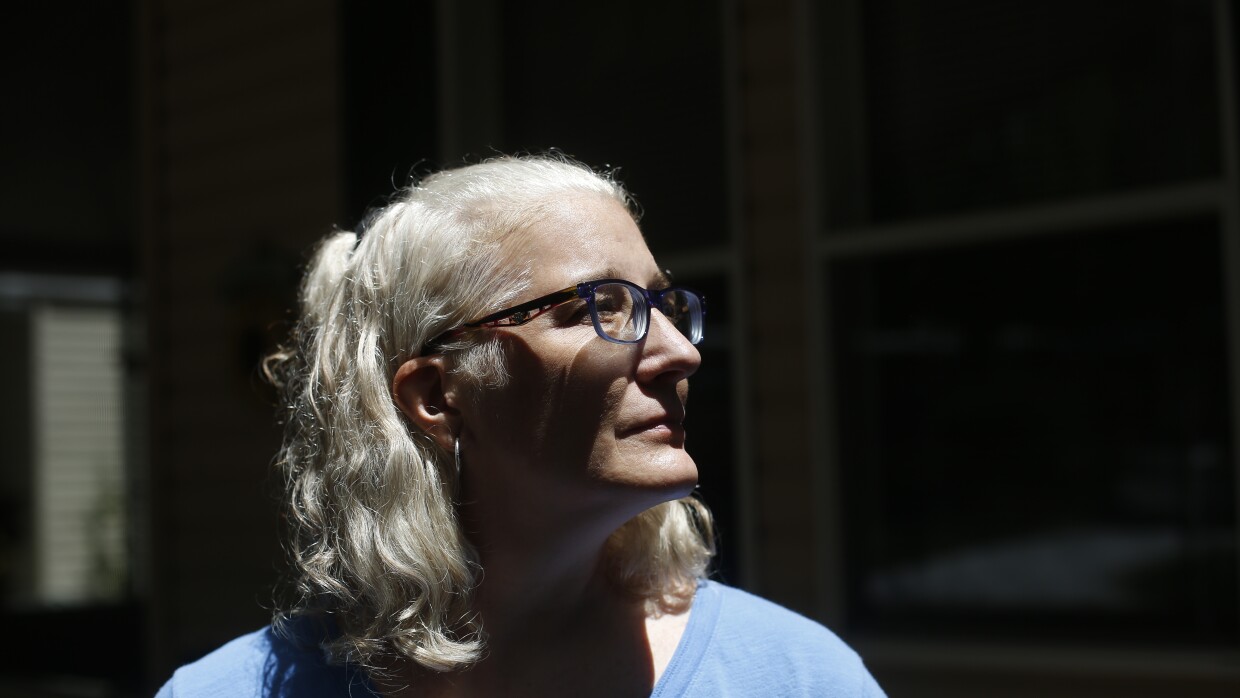 Melissa Preen stands beside boxes filled with her belongings as she prepares to move back to Cleveland, Ohio. She says she can no longer afford to live in Country Villa Estates in Riverview, Florida, due to rising lot rent and other fees.