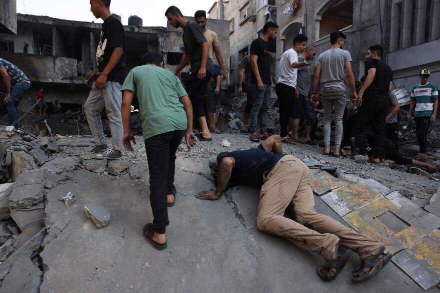 Wed., Oct. 11: Palestinians look for survivors under the rubble of a building following an Israeli airstrike in Gaza City.