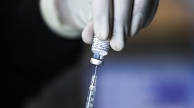 A pharmacy technician prepares doses of the Pfizer-BioNTech COVID-19 vaccine at a mass vaccination event on Saturday in Denver.