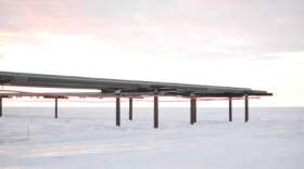 A flow line curves above the horizon on the western North Slope. ConocoPhillips wants to expand one of its units in the region. (Elizabeth Harball/Alaska’s Energy Desk)