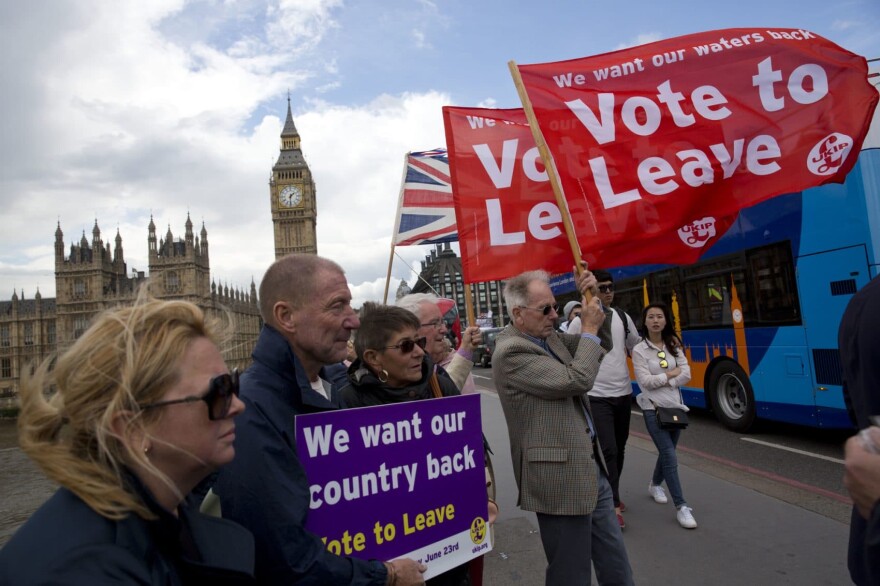 Leave supporters hold banners and flags as they stand on Westminster Bridge during an EU referendum campaign stunt in which a flotilla of boats supporting "Leave" sailed up the River Thames outside the Houses of Parliament in London, Wednesday, June 15, 2016. A flotilla of boats protesting EU fishing polices has sailed up the River Thames to the Houses of Parliament as part of a campaign backing Britain's exit from the European Union. The flotilla was greeted by boats carrying "remain" supporters. (Matt Dunham/AP)