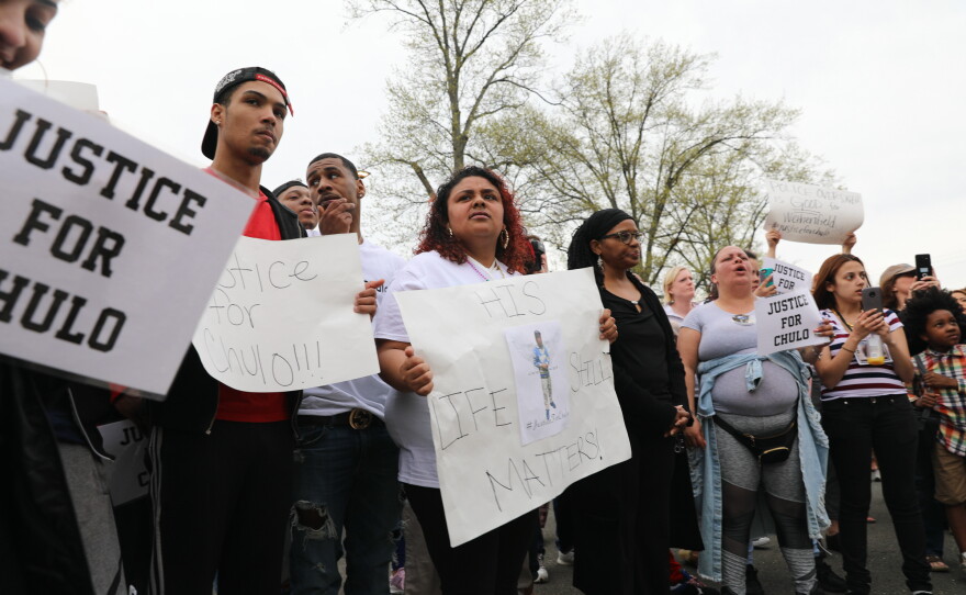 Indriannie Rosado, 23, holding up the 'His Life Still Matters'  sign at center, says Chulo was a close friend of hers.
