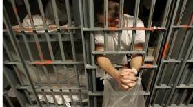 An inmate leans out the bars of his cell in a one-prisoner-per-cell block in downtown Los Angeles.