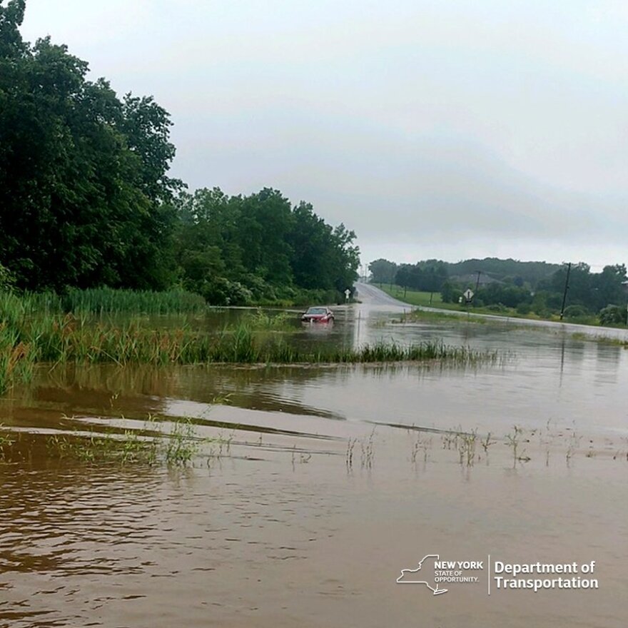 A car drifts into the water after attempting to cross a flooded road in Ontario County Monday, July 10, 2023.