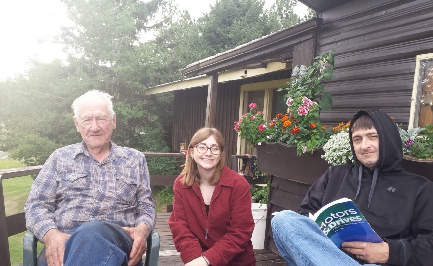Angie's grandpa John, her daughter Anna, and her husband Chris on the deck at the ranch in Custer, SD.