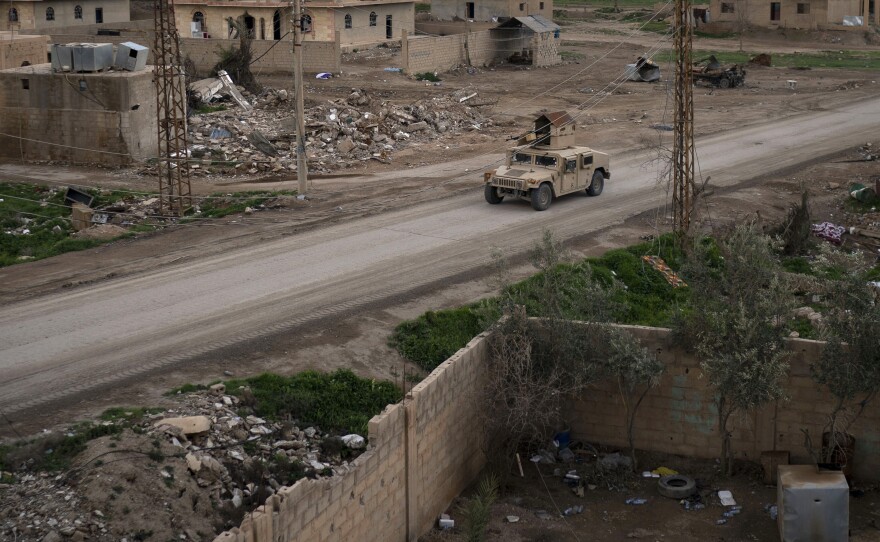 A Humvee drives in a village recently retaken from Islamic State militants by U.S.-backed Syrian Democratic Forces (SDF) near Baghouz, on Feb. 17.