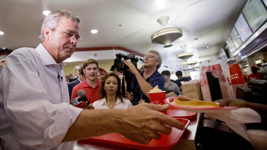 Jeb Bush is handed a "yellow dog" at Varsity Drive-In last month in Atlanta. That's a hot dog with mustard.