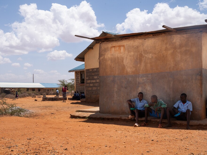 Morans must always eat together. And it's strictly forbidden for them to do so within sight of girls. So Saidimu, Loshaki and Paris take their lunch in a hiding spot behind the cafeteria building.