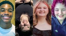 Photo of four teenagers smiling. 