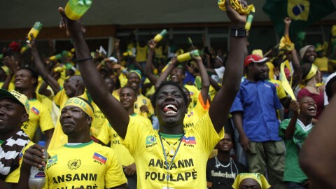 Fans of Brazil's soccer team cheer during the South Africa 2010 World Cup match between Brazil and Ivory Coast as they watch the game from Sylvio Cator stadium in Port-au-Prince, Sunday, June 20, 2010. (AP Photo/Alexandre Meneghini)