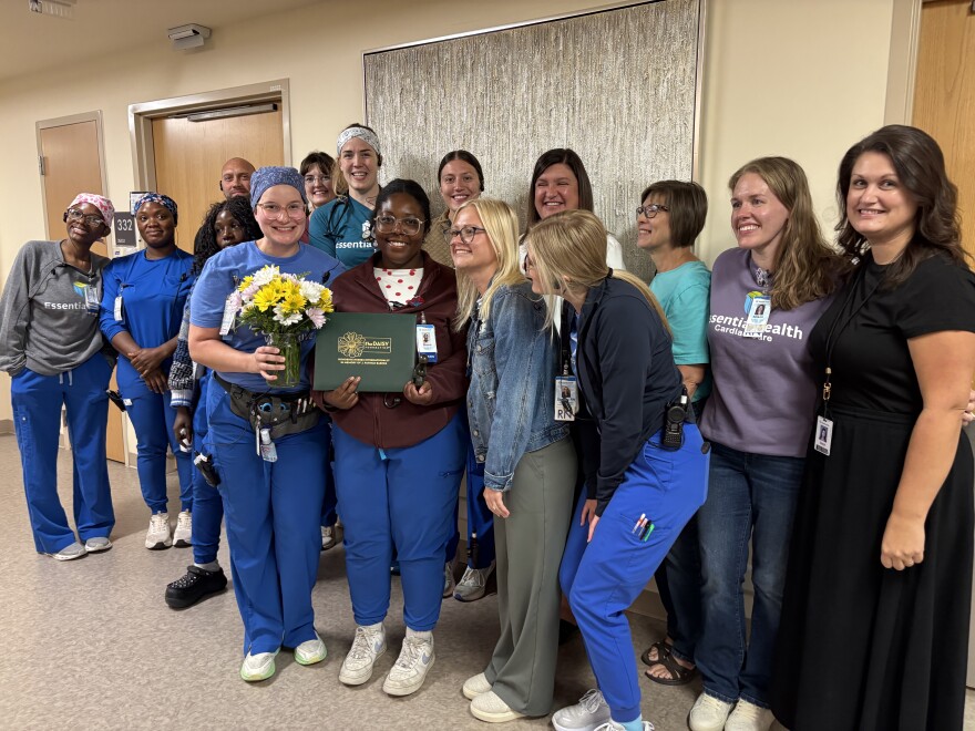Shana Bennefield, center, holds her DAISY award with her nursing colleagues at Essentia Health in Fargo.
