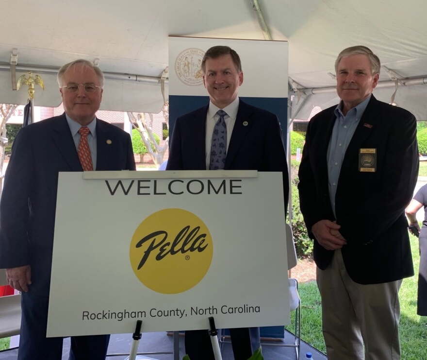 North Carolina officials Jay Donecker and Tony Copeland stand with Tim Yaggi, then CEO of Pella Corporation, in 2019.
