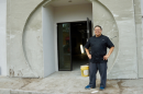 Blue Bamboo owner Dennis Chan poses in the doorway of the building he is renovating at 10110 San Jose Blvd.