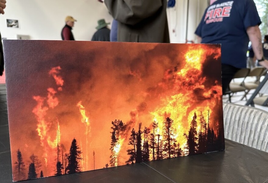 Photo on display showing trees on fire. 