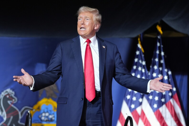 Republican presidential candidate former President Donald Trump gestures to the crowd as he arrives to speak at a campaign rally, July 31, 2024.