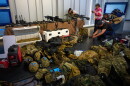 FILE - Weapons that Cuban authorities say were recovered from a speedboat in Cuban waters following a confrontation that left four people dead are displayed during a media presentation in Havana, Feb. 27, 2026.