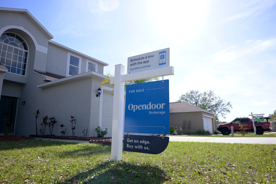 FILE - Real estate signs are posted outside homes for sale, Feb. 21, 2023, in Valrico, Fla.