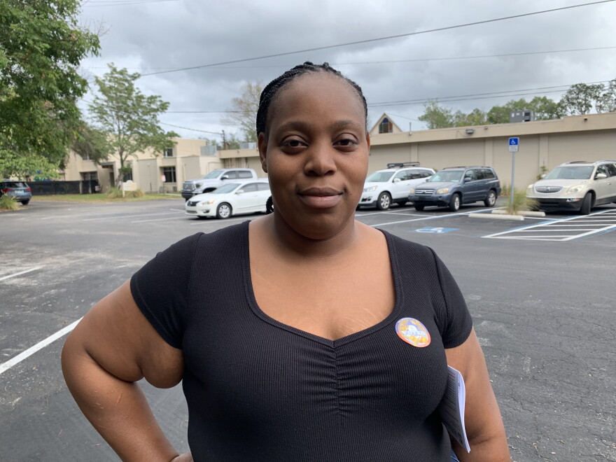Person in a black shirt wearing an "I Voted" sticker
