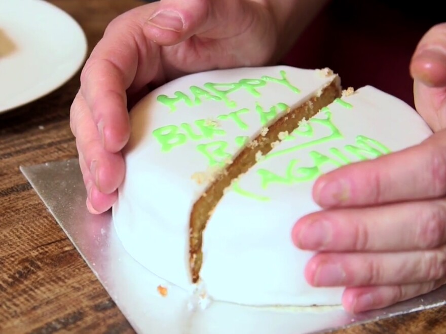 Alex Bellos seals up the cake after removing a slice.
