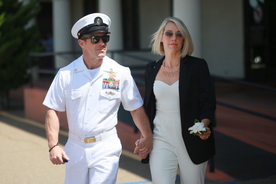 Navy Special Operations Chief Edward Gallagher walks out of military court with his wife Andrea Gallagher, during court recess on July 2, 2019, in San Diego, Calif. He was pardoned by President Trump after being convicted of posing with a teenage ISIS captive's body. He was acquitted of murder.