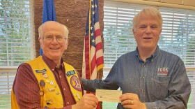 Three Lakes Lions Treasurer Don Meeder presents a check for $500.00 in support of FORK's planned expansion into the Three Lakes School District.