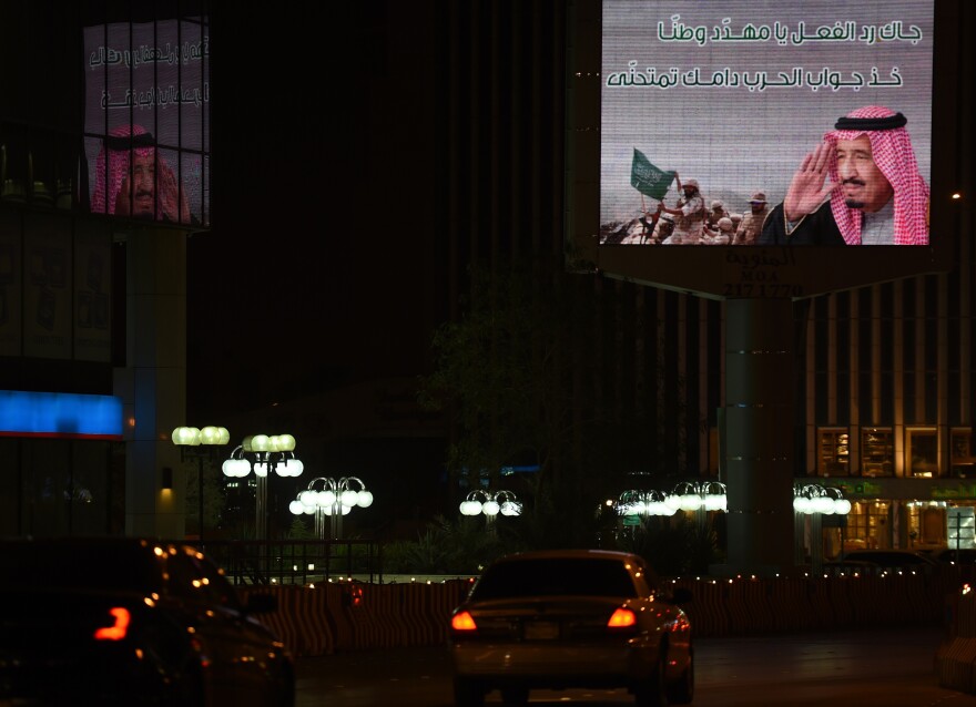 A billboard in Riyadh, the Saudi capital, features an image of soldiers and a portrait of Saudi King Salman.
