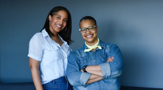 Aviatrix playwright Angela Poe Russell and composer Dionne McClain-Freeney pose for photos inside KNKX's Seattle office.