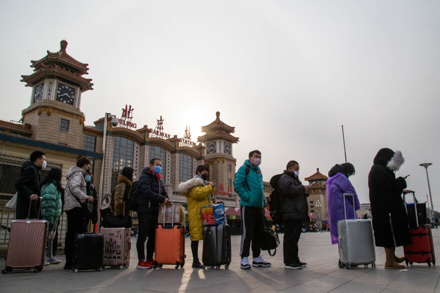 Travelers wait for taxis at the Beijing's train station.