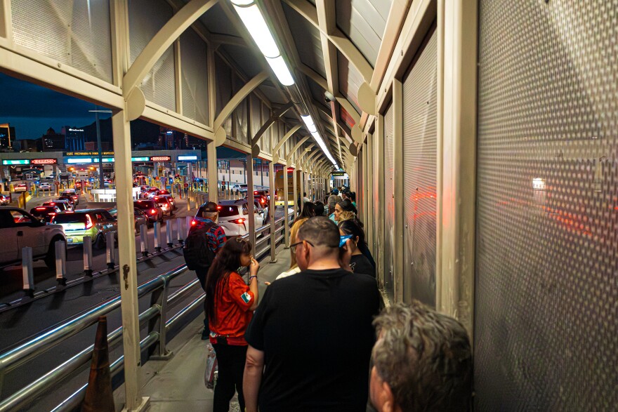 People stand in line at the Santa Fe International Bridge waiting to cross from Ciudad Juarez to El Paso. 

