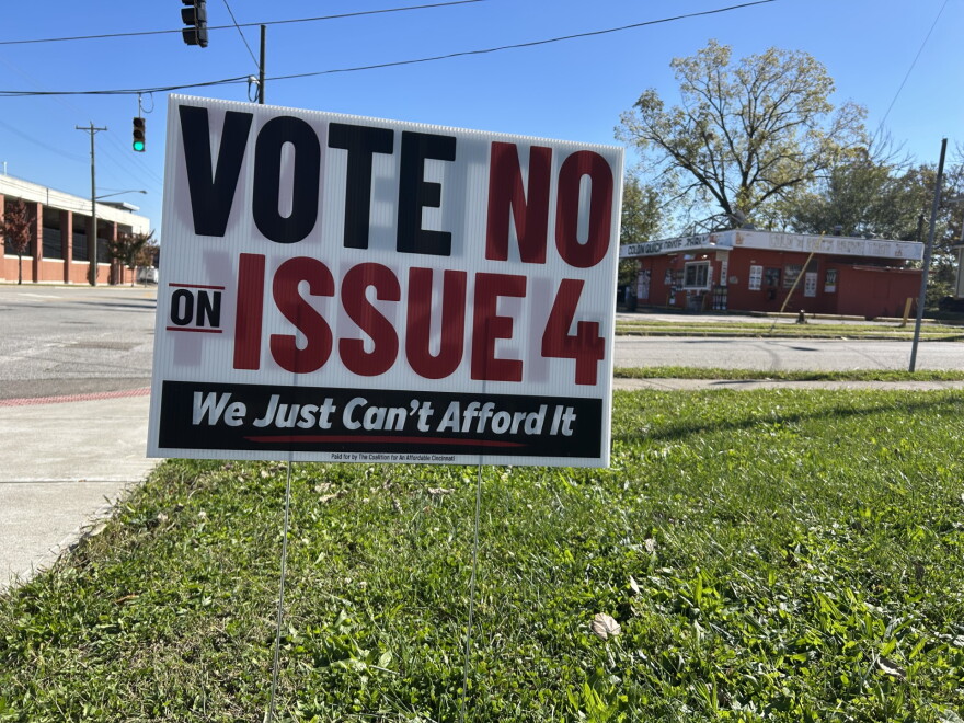 A yard sign on a corner in Evanston reads "Vot No on Issue 4. We just can't afford it."