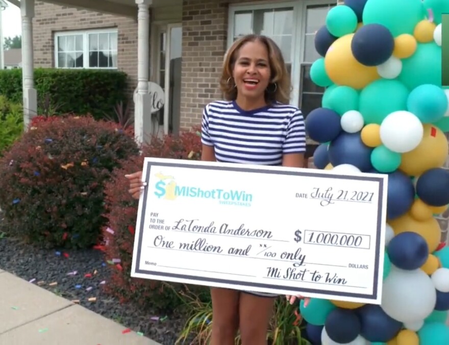 LaTonda Anderson holding a big check for $1 million