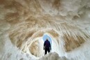 Juniper Schaberg stands tall at the entrance of an ice cave at Sleeping Bear Point over the weekend. (Photo courtesy of James Schaberg)