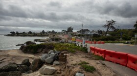 Orange barriers line part of the road next to the ocean on West Cliff Drive.
