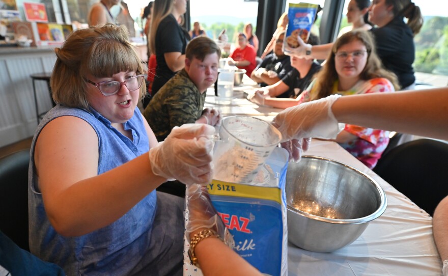 Paige Hennigan measures the pancake mix.