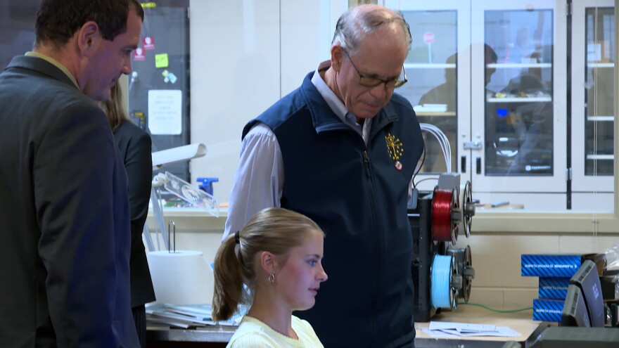 Indiana governor Mike Braun and Bloomfield schools superintendent Scott Van Der Aa watch as a Bloomfield High School student shows classwork on a computer Monday in Bloomfield.