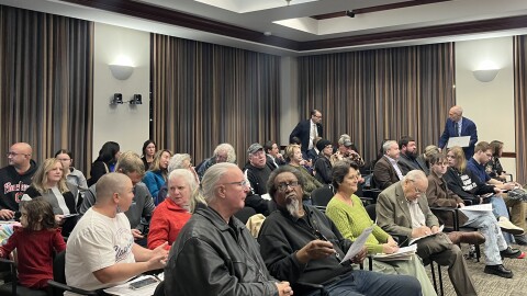 People sit in nearly every chair in Hamilton's City Council Chambers.